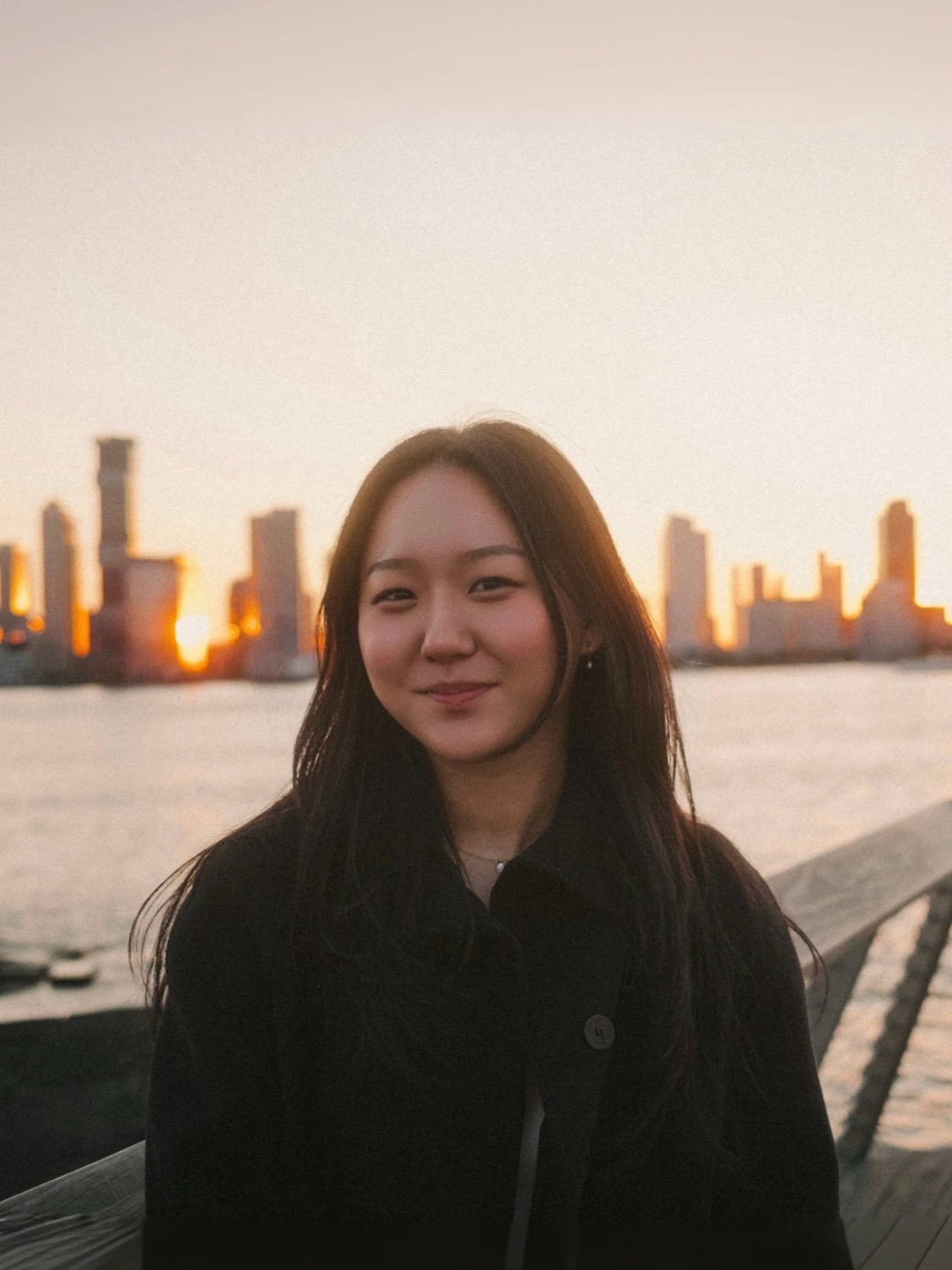 Helen in NYC, with the skyline behind her